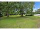 Large, well-maintained front lawn with mature trees offering shade and privacy at 300 Crescent Dr., Conway, SC 29526