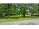 Well-maintained front yard features mature trees and lush greenery for an inviting curb appeal at 300 Crescent Dr., Conway, SC 29526