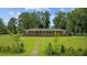 Charming brick home features a well-manicured lawn with landscaped flower beds and a brick walkway at 300 Crescent Dr., Conway, SC 29526