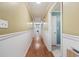Long hallway with hardwood flooring, white trim, and neutral-toned walls at 300 Crescent Dr., Conway, SC 29526