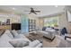 Cozy living room features plush seating, neutral carpet, a ceiling fan, and large windows at 300 Crescent Dr., Conway, SC 29526