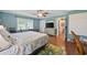 Bright bedroom features hardwood floors, a ceiling fan, and ample natural light at 300 Crescent Dr., Conway, SC 29526