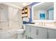Well-lit bathroom featuring a shower/tub combo, modern vanity and shelving at 3000 N Ocean Blvd. # 209, Myrtle Beach, SC 29577