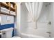 Clean bathroom featuring a shower and bath combo with a wooden storage shelf at 3000 N Ocean Blvd. # 209, Myrtle Beach, SC 29577