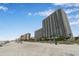 Expansive beachfront view of a high-rise condominium complex on a sunny day at 3000 N Ocean Blvd. # 209, Myrtle Beach, SC 29577