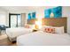 Inviting bedroom with two beds, beach-themed art, and access to a private balcony at 3000 N Ocean Blvd. # 209, Myrtle Beach, SC 29577