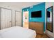 This bedroom features a bright blue wall, a dresser, a mirror, and a closet at 3000 N Ocean Blvd. # 209, Myrtle Beach, SC 29577