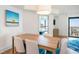 Cozy dining area with seating for six, overlooking a bedroom and balcony with ocean views at 3000 N Ocean Blvd. # 209, Myrtle Beach, SC 29577