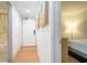 Bright hallway leading to a bedroom and bathroom showcasing wood floors and a modern aesthetic at 3000 N Ocean Blvd. # 209, Myrtle Beach, SC 29577