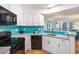 Modern kitchen showcasing white cabinetry, stainless steel appliances, and a sleek design at 3000 N Ocean Blvd. # 209, Myrtle Beach, SC 29577