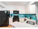 Well-equipped kitchen featuring white cabinets, stainless steel appliances, and a stylish backsplash at 3000 N Ocean Blvd. # 209, Myrtle Beach, SC 29577