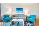 Comfortable living room featuring a contemporary sofa, chairs, artwork, and wood-style flooring at 3000 N Ocean Blvd. # 209, Myrtle Beach, SC 29577