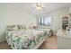 Comfortable bedroom with floral bedding, ample natural light, and classic furnishings at 305 Hillside Dr. N # 205, North Myrtle Beach, SC 29582