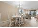 Bright dining area with a white table, chairs, and a view of the living room at 305 Hillside Dr. N # 205, North Myrtle Beach, SC 29582