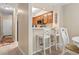 Kitchen bar top with stools, wood cabinets, and a view to the hallway at 305 Hillside Dr. N # 205, North Myrtle Beach, SC 29582