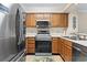 Kitchen with stainless steel appliances, wood cabinets, and white countertops at 305 Hillside Dr. N # 205, North Myrtle Beach, SC 29582