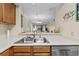 Kitchen showcasing a stainless steel sink and a view to the dining and living areas at 305 Hillside Dr. N # 205, North Myrtle Beach, SC 29582