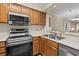 Kitchen with stainless steel appliances, wood cabinets, and breakfast bar at 305 Hillside Dr. N # 205, North Myrtle Beach, SC 29582