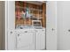 Laundry room with a white washer and dryer and wire shelving at 305 Hillside Dr. N # 205, North Myrtle Beach, SC 29582