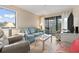 Cozy living room with plush seating, bright decor, and sliding glass doors leading to a patio at 305 Hillside Dr. N # 205, North Myrtle Beach, SC 29582