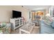 Comfortable living room showcases stylish furniture, a large TV, and glimpses of the kitchen and dining area at 305 Hillside Dr. N # 205, North Myrtle Beach, SC 29582