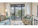 Relaxing screened patio offers seating, shade, and a partial view of the surrounding property at 305 Hillside Dr. N # 205, North Myrtle Beach, SC 29582