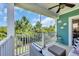 Inviting porch with wicker seating, a ceiling fan and views of lush trees and landscaping at 305 Splendor Circle, Murrells Inlet, SC 29576