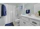 Well-lit bathroom featuring a vanity sink, decorative shower curtain, and blue accents at 305 Splendor Circle, Murrells Inlet, SC 29576