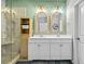 Bathroom featuring double vanity, decorative mirrors, and glass enclosed shower with shelving at 305 Splendor Circle, Murrells Inlet, SC 29576