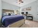 A comfortably furnished bedroom with a bed, desk, two monitors, and a ceiling fan at 305 Splendor Circle, Murrells Inlet, SC 29576