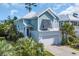 Two-story home with blue siding, white trim, a two-car garage and lush landscaping at 305 Splendor Circle, Murrells Inlet, SC 29576