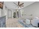 Open living room featuring hardwood floors, ceiling fan, stairway, and light gray walls at 305 Splendor Circle, Murrells Inlet, SC 29576