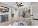 Open living room featuring hardwood floors, ceiling fan, stairway, and light gray walls at 305 Splendor Circle, Murrells Inlet, SC 29576