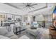 Open-concept space with living room area featuring wood floors, gray sofas, and an adjacent kitchen at 305 Splendor Circle, Murrells Inlet, SC 29576