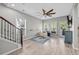Open living room featuring hardwood floors, ceiling fan, stairway, and light gray walls at 305 Splendor Circle, Murrells Inlet, SC 29576