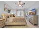 Calm bedroom with a tufted headboard, dresser, flat screen television, and plenty of natural light at 305 Splendor Circle, Murrells Inlet, SC 29576