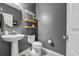 Stylish powder room features gray walls, floating shelves, and a modern pedestal sink at 305 Splendor Circle, Murrells Inlet, SC 29576
