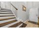 Elegant staircase with wood treads, white risers, and a modern handrail at 305 Splendor Circle, Murrells Inlet, SC 29576