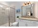 Bathroom featuring a glass shower, granite countertop vanity with a large mirror and modern lighting at 3185 Viceroy Loop, Little River, SC 29566