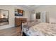 Comfortable bedroom with hardwood floors, a metal frame bed, and a view of modern wall art at 3185 Viceroy Loop, Little River, SC 29566