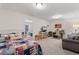 Bedroom with a colorful quilt, a work station, a seating area with a sofa, and an open view into another room at 3185 Viceroy Loop, Little River, SC 29566