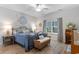 Cozy bedroom featuring a wrought iron bed, blue bedding, and a window with natural light at 3185 Viceroy Loop, Little River, SC 29566