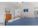 Bedroom showcasing a bed with blue bedding, with a view into an adjacent room with kitchen cabinetry at 3185 Viceroy Loop, Little River, SC 29566