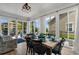 Sunlit dining room with large windows, a dining table set for meals, and stylish seating at 3185 Viceroy Loop, Little River, SC 29566