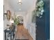 Inviting entryway with stylish decor, hardwood floors, and decorative wreath on the front door at 3185 Viceroy Loop, Little River, SC 29566