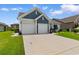 Charming home with two-car garage, beautiful landscaping, and a well-maintained lawn at 3185 Viceroy Loop, Little River, SC 29566