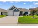 Charming home with a two-car garage and well-manicured front lawn and landscaping at 3185 Viceroy Loop, Little River, SC 29566