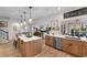 Bright kitchen with an island, stainless steel appliances, and a view into the living and dining areas at 3185 Viceroy Loop, Little River, SC 29566