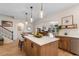 Spacious kitchen featuring a large island with seating and modern lighting fixtures at 3185 Viceroy Loop, Little River, SC 29566