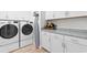 Bright laundry room featuring modern washer and dryer units, cabinetry, and granite countertops at 3185 Viceroy Loop, Little River, SC 29566